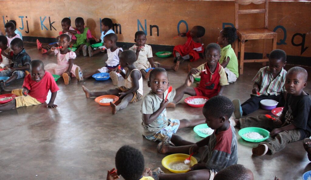 Children at a preschool eating daily vitamin-enriched porridge,